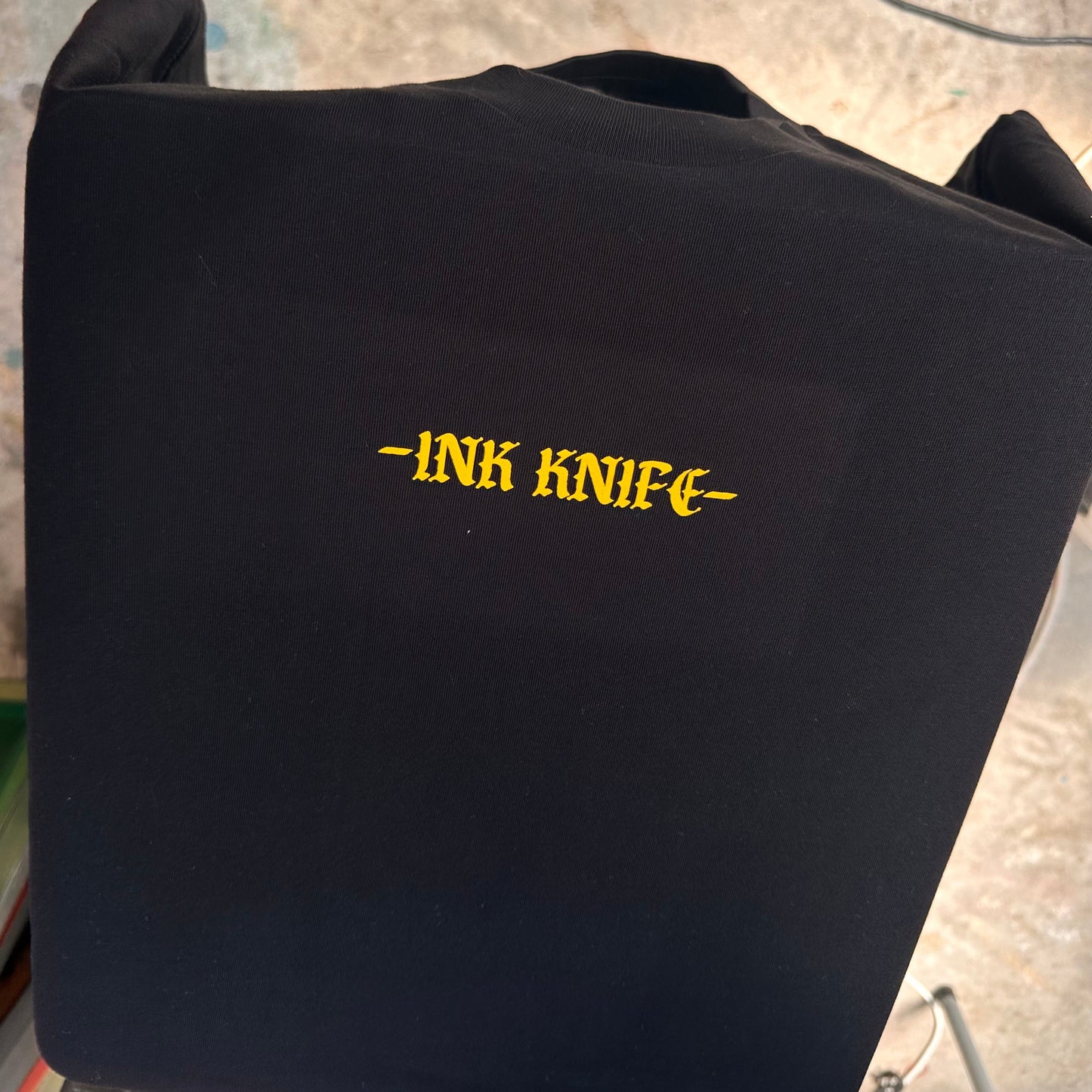 Niue seal yellow ink on black tee