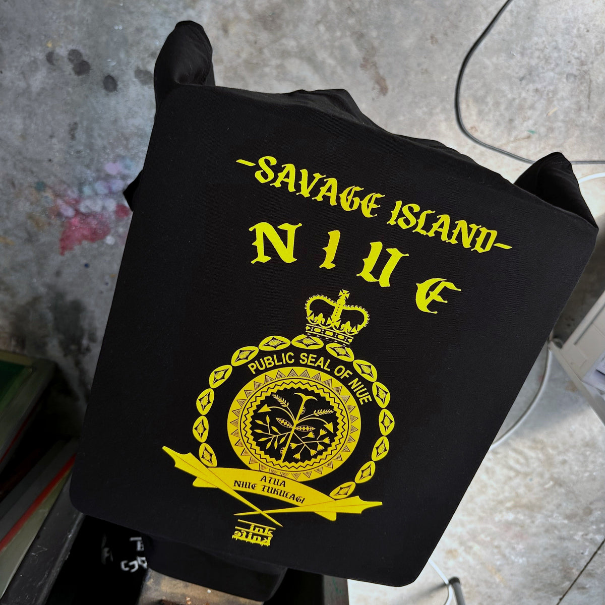 Niue seal yellow ink on black tee