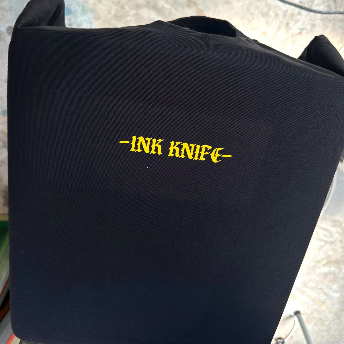 Niue seal yellow ink on black tee