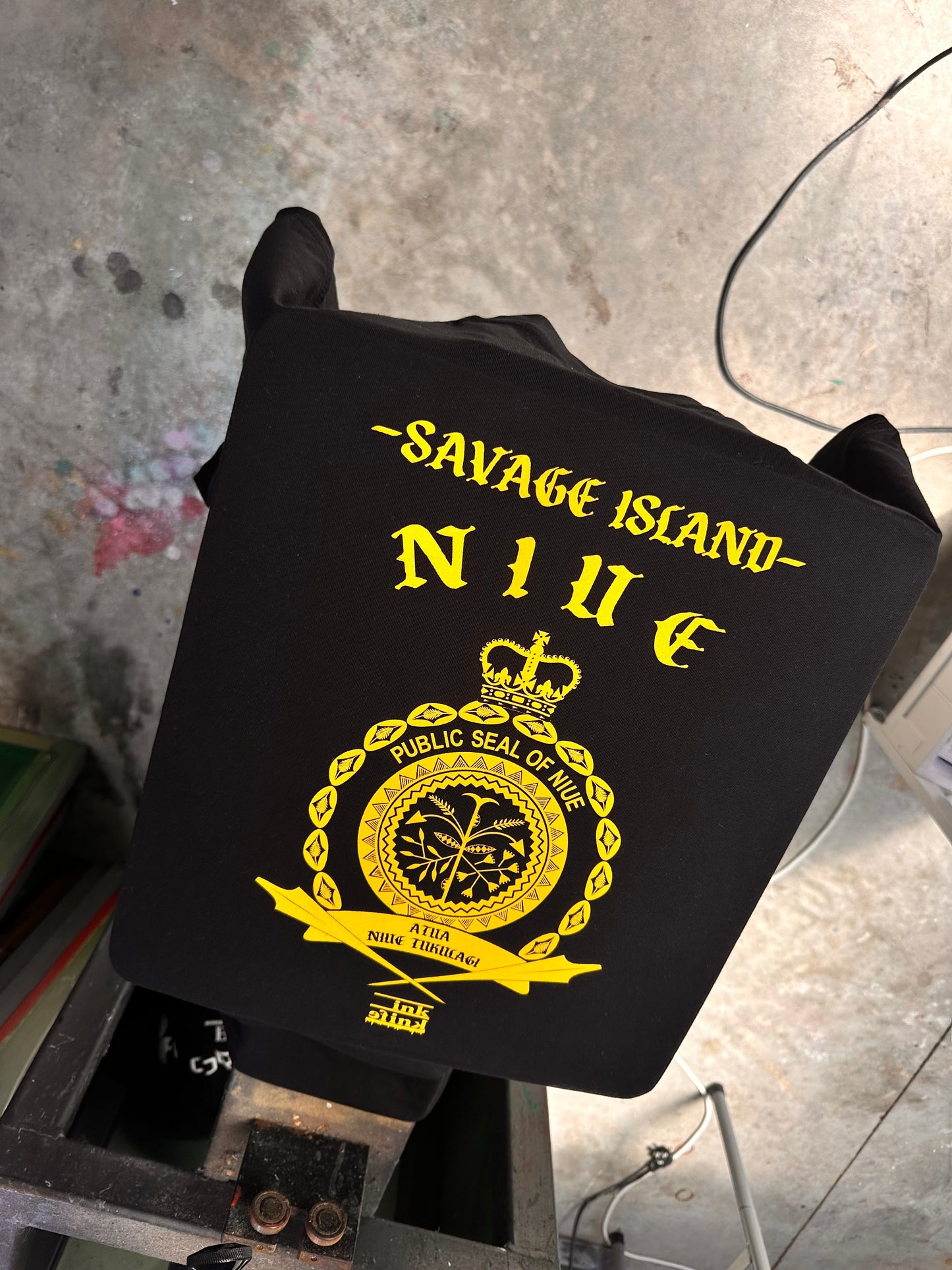 Niue seal yellow ink on black tee